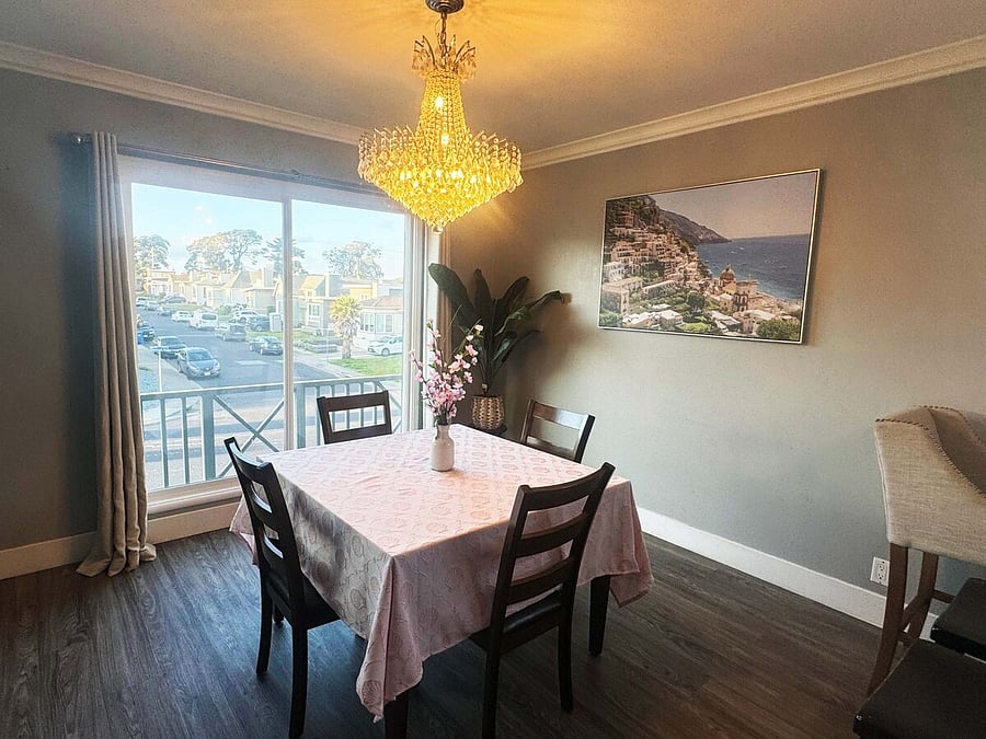 Dining area with chandelier and bright street-view windows