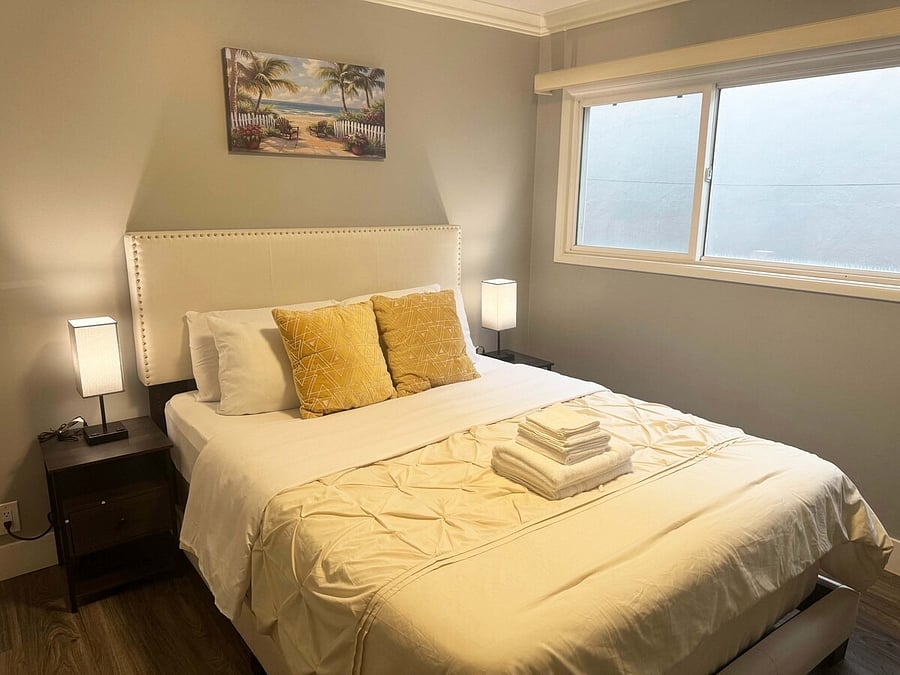 Room 3: Bright bedroom with a large window