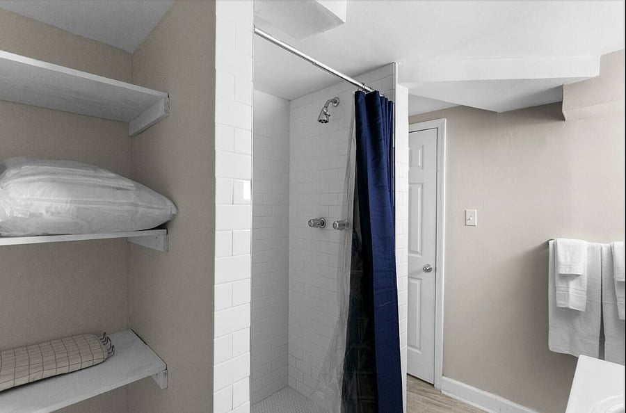 Enjoy a simple, functional bathroom setup with a stand-up shower, stocked and ready to keep your routine comfortable and stress-free.