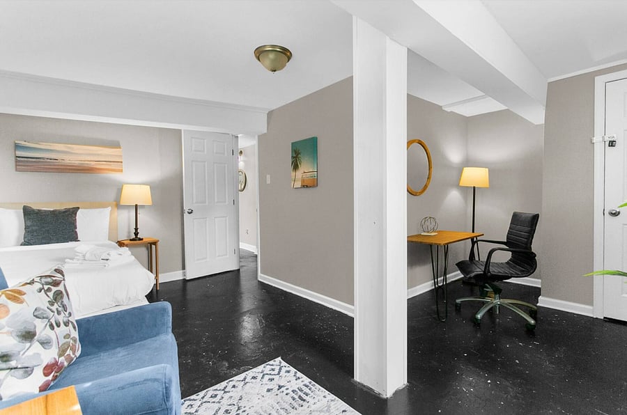 Get work done with ease in a thoughtfully placed workspace, set apart within the twin bedroom by a small wall for added privacy and focus.