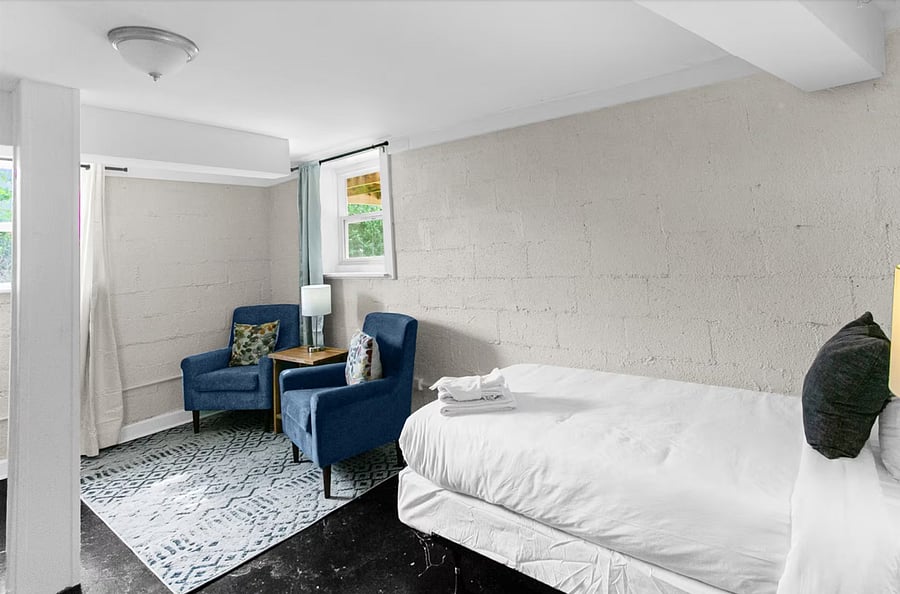 Settle into a comfortable twin bed with a dedicated seating space nearby, creating a private spot to unwind or recharge.