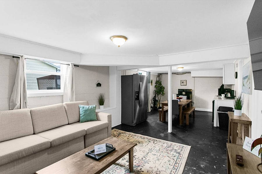 Relax in a bright, open living room featuring comfortable seating and a Smart TV-perfect for unwinding after a full day out.