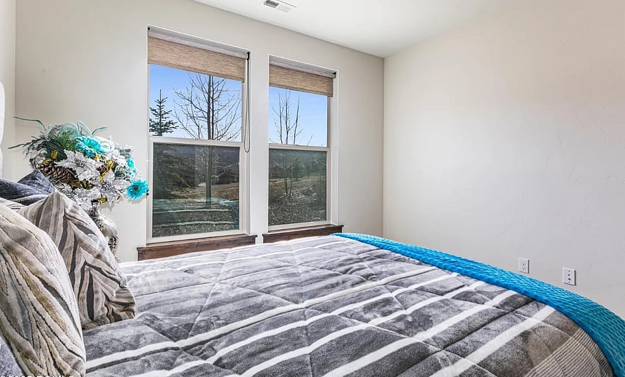 Ground level bedroom with queen bed.