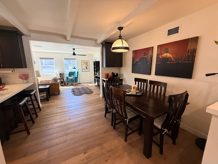 Dining room, with view of passage into the kitchen (to the left) and second living room beyond.