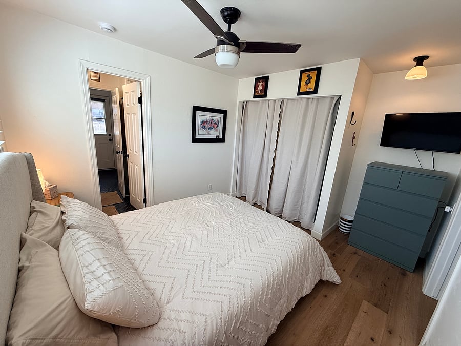 Another angle of the room for rent. Spacious around the bed, with the dresser tucked into a nook, below a flatscreen TV. Large closet as well.