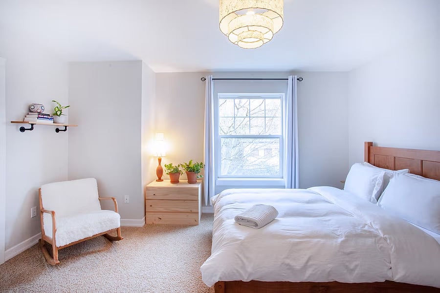 Master bedroom with queen bed, large walk in closet, chair, desk and ensuite bathroom