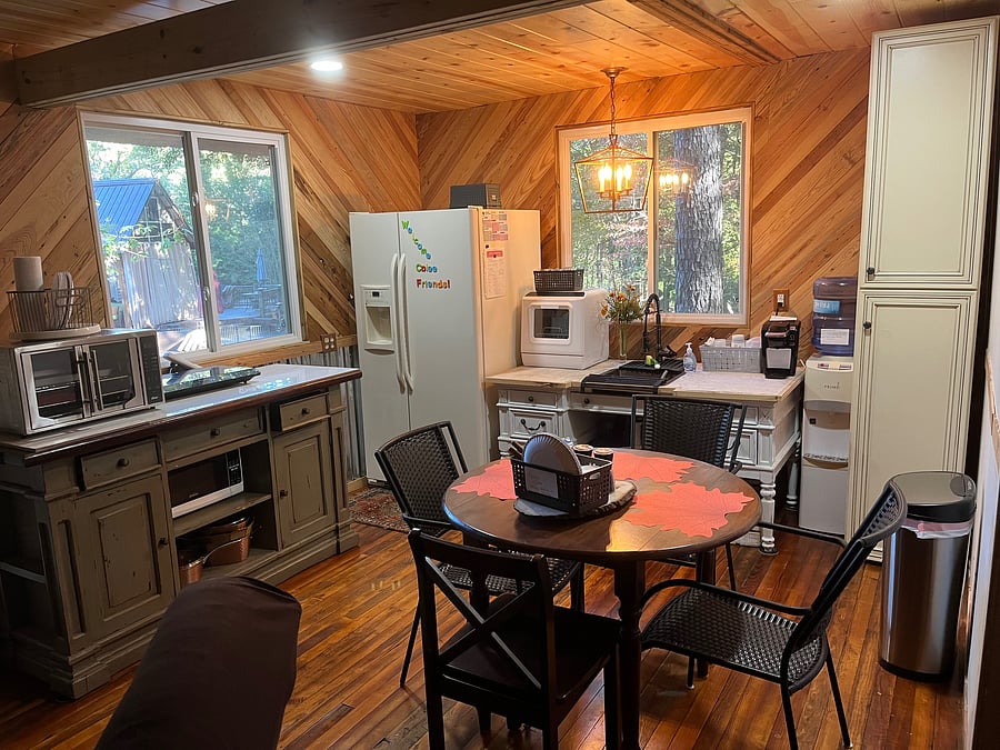 Eat in kitchen. Toaster oven that cooks full size 16" pizza. Tabletop infrared cooktop with non toxic copper stainless steel pans
Full sized refrigerator
Tons of cabinet storage. Crockpot, ninja blender, keurig coffee machine, filtered water dispenser