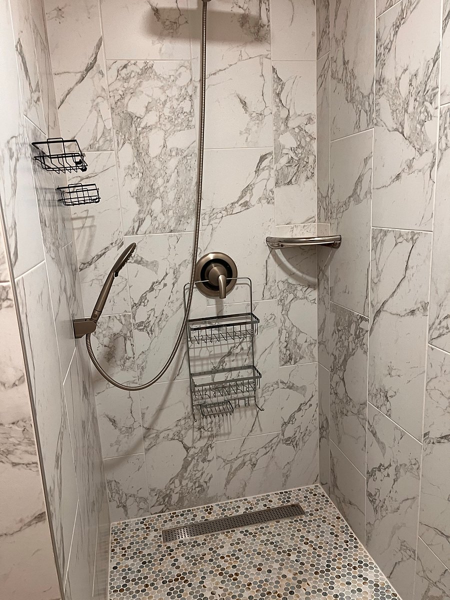 Brand new tiled walk in rain shower. Bathroom is large with brand new laminate floors and more storage for your toiletries