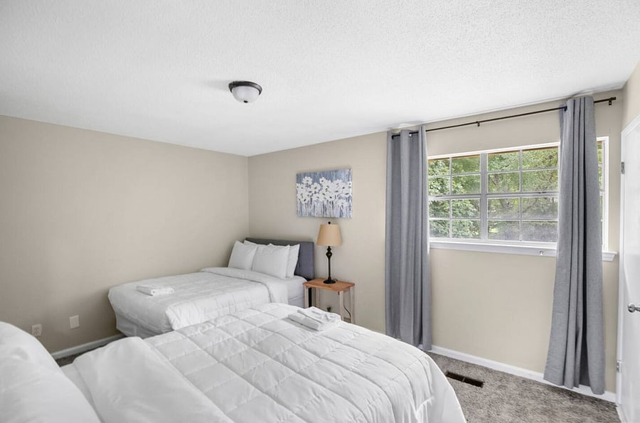 Designed for easy group living, this bedroom features two full beds and a layout that feels open yet cozy. It's a dependable, comfortable space to unwind after a day spent together.
