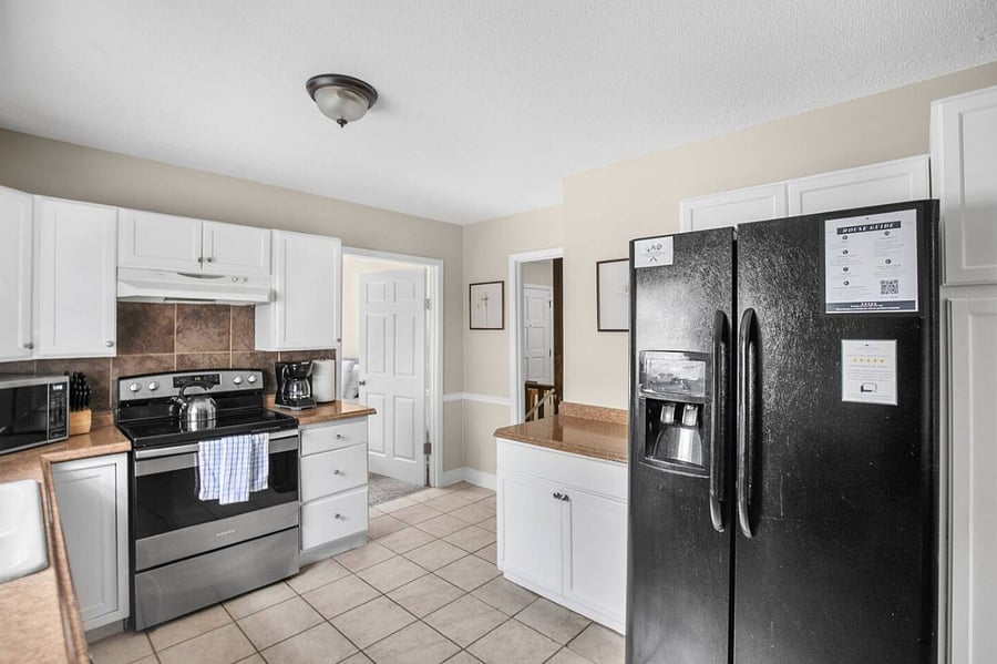 The upstairs kitchen is bright, open, and fully equipped with everything you need, including a dishwasher for easy cleanup-so you can spend less time working and more time enjoying your stay.