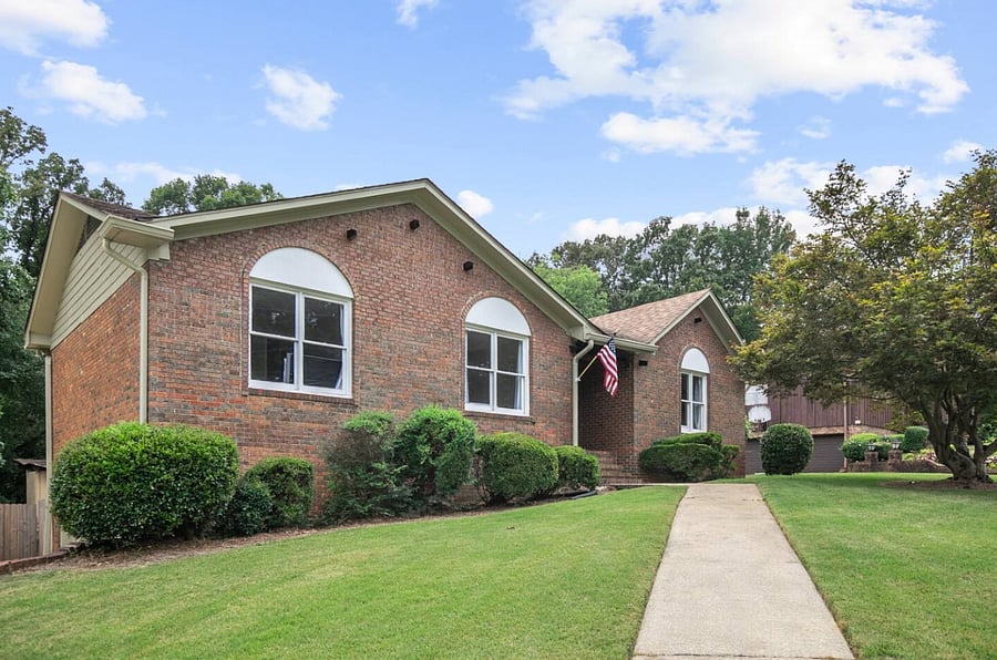 This view of the front of the home highlights the inviting walkway leading you to the entrance-an easy, welcoming path that sets the tone for a smooth arrival and a stay that begins the moment you step inside.