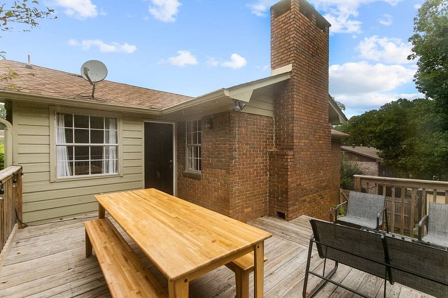 With plenty of room to gather, the picnic table creates an easy, casual space for dining and conversation, all set against the backdrop of the home's private backyard.