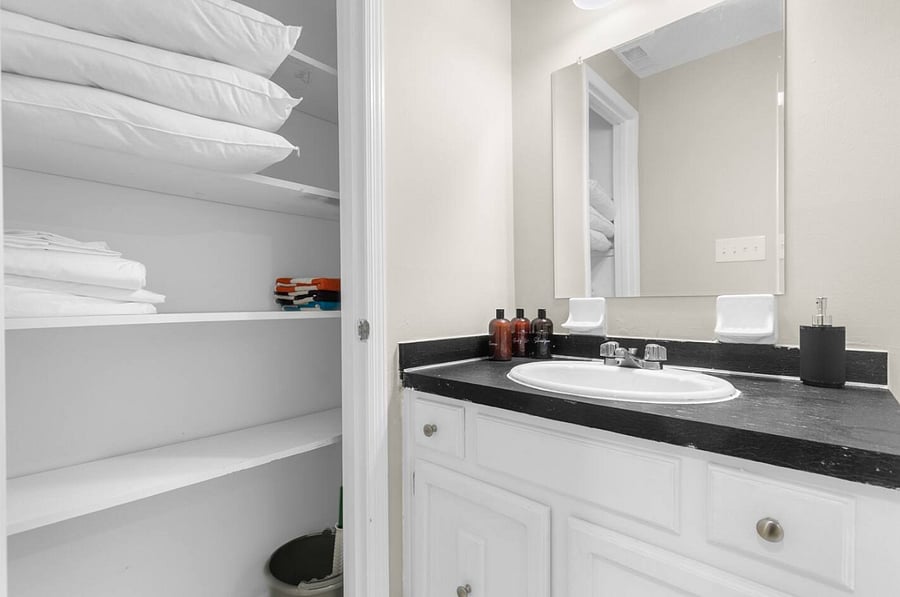 Bright and thoughtfully maintained, this downstairs bathroom includes a walk-in shower and is fully stocked with towels and everyday essentials-so you can settle in without needing to think twice.