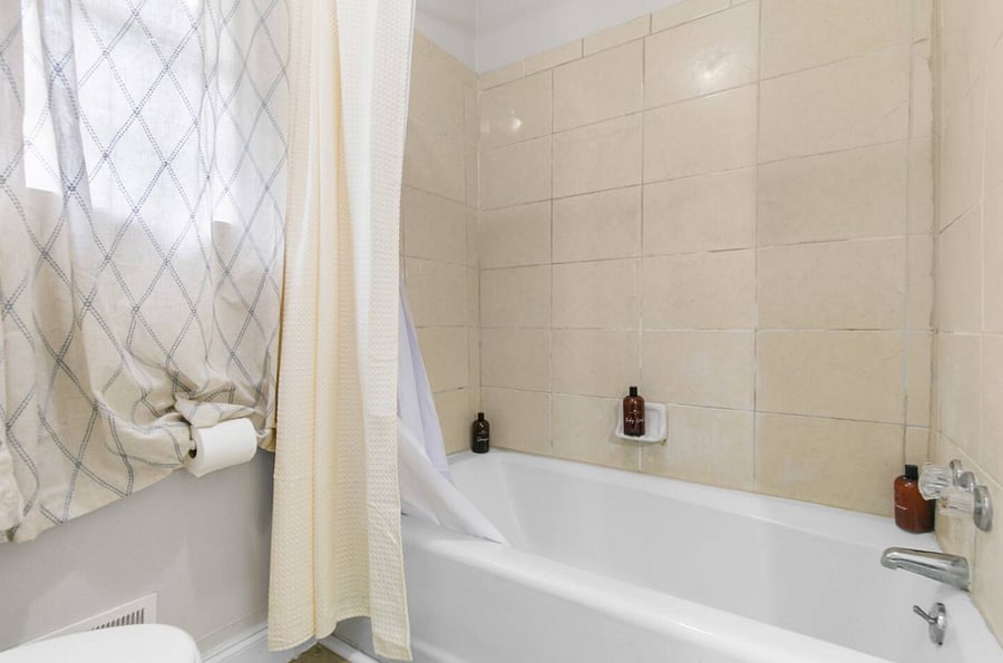 The second upstairs bathroom features a convenient tub and shower combination, offering flexibility whether you prefer a quick rinse or a more relaxed, end-of-day soak.