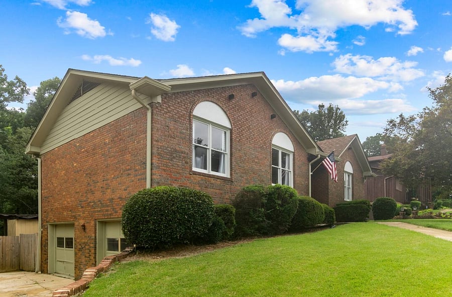 From this wider view, the home's layout really comes into perspective-with the garage set just down the hill on the lower level and a clear walkway leading up to the front door, creating an easy, natural flow from arrival to entry.
