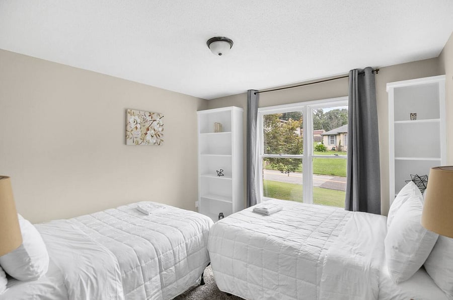 A second double full bedroom offers the same inviting comfort, with two full beds perfectly suited for sharing. It's a bright, easygoing space where guests can recharge and settle in after a full day together.