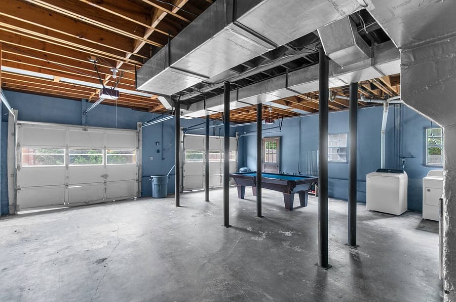 The garage offers a versatile setup with one open, spacious side and the other featuring a pool table ready for friendly competition-creating a fun, casual hangout space right at home.
