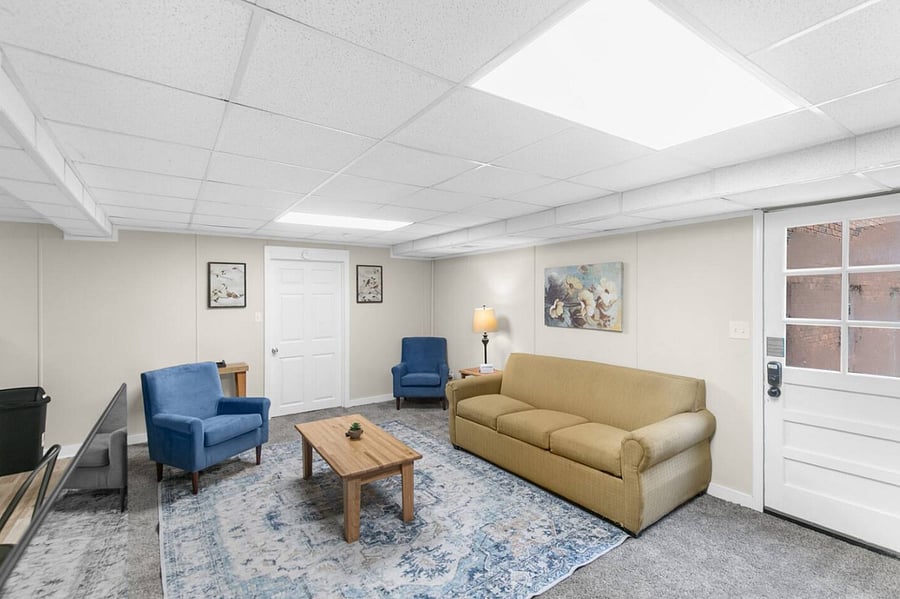 The downstairs living area offers a relaxed, comfortable space to unwind, complete with a queen sofa bed for added flexibility. It's perfect for movie nights, casual conversations, or simply stretching out after a full day.