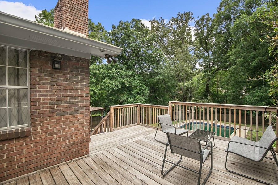 A comfortable seating area on the porch invites you to sit back and relax, whether you're enjoying a quiet moment alone or catching up with friends in a shaded, peaceful setting.