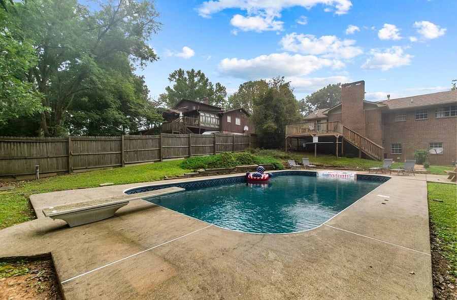 With a diving board ready for a little extra fun, the pool becomes the heart of the outdoor space-perfect for making memories, sharing laughs, and enjoying those carefree, sun-filled moments.