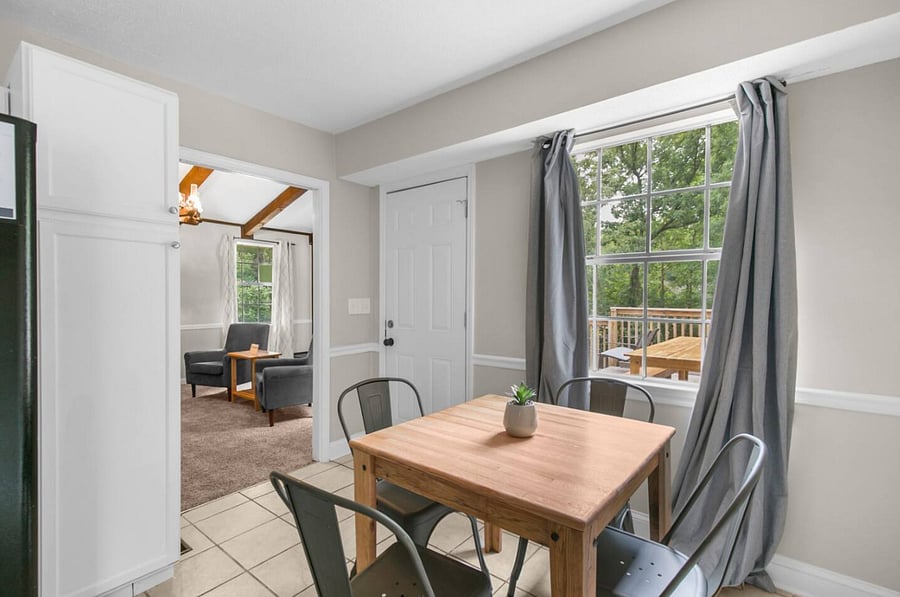 The upstairs dining area offers a comfortable setting for four, perfectly positioned within the kitchen space for easy, connected meals and conversation.