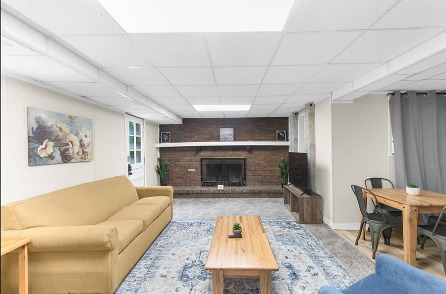 A decorative fireplace adds a cozy touch to this downstairs living area, creating a warm, welcoming atmosphere. Paired with the queen sofa bed, it's a space that blends comfort, style, and practicality.