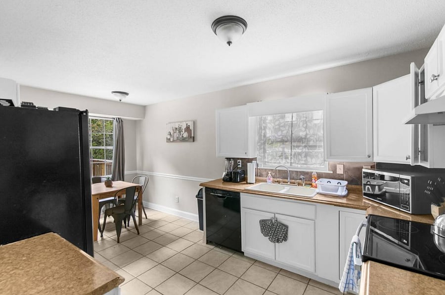 Designed for both function and flow, the kitchen features an oven, microwave, dishwasher, and plenty of space to prep meals while staying connected to the rest of the home.