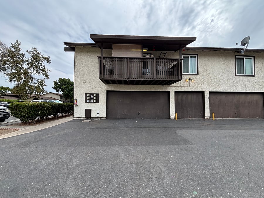 Detached garage around the corner for one vehicle or storage (manual door), plus ample parking in the patrolled lot near the front door