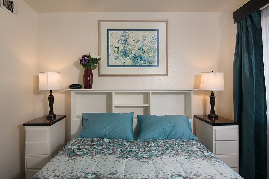 Settle into the left bedroom with ocean-inspired artwork and coordinated blue bedding.