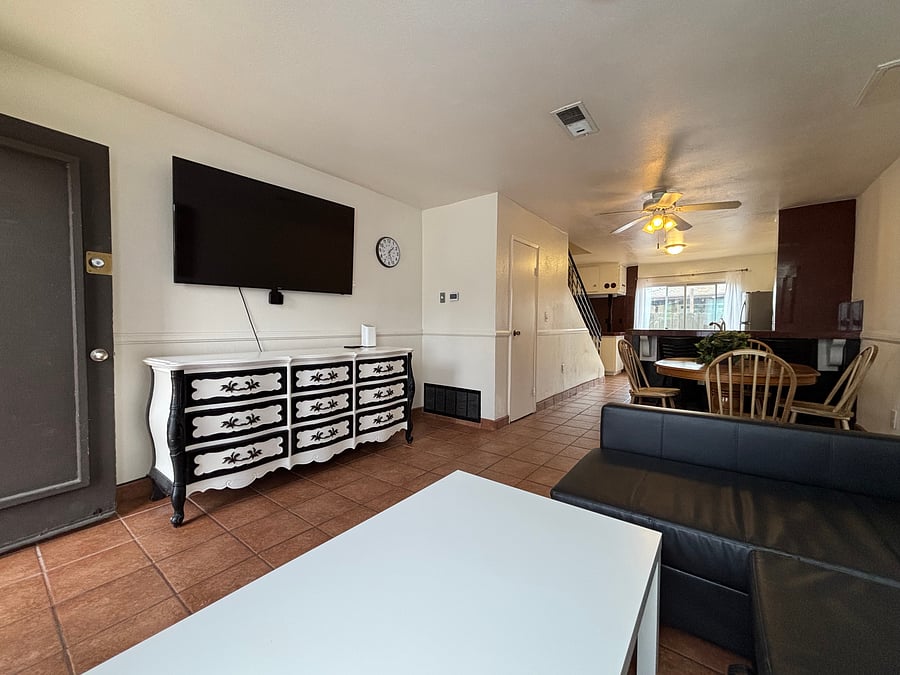 Enjoy a movie on the wall-mounted TV, with the dining area and kitchen just steps away