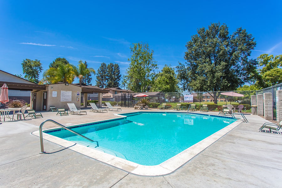 Cool off in the shared community pool or relax poolside with lounge chairs and umbrella-shaded seating