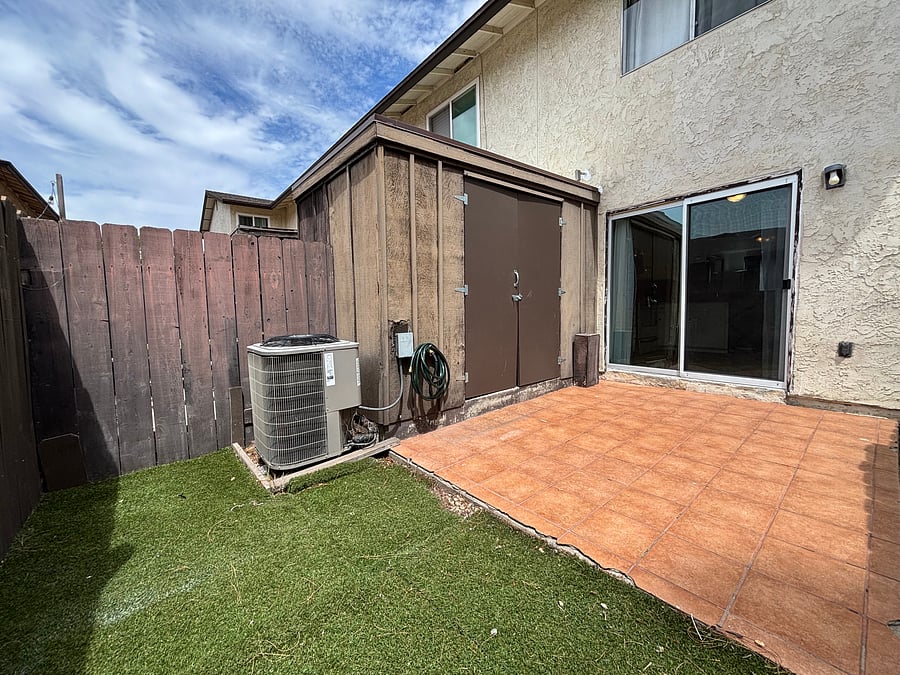 Step outside to a fenced backyard with a tiled patio and artificial turf-a little space to enjoy the Santee sunshine