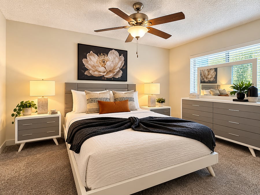 Spacious and comfortably furnished primary bedroom with a cozy, relaxing feel, generous storage, and convenient access to the private ensuite bath.