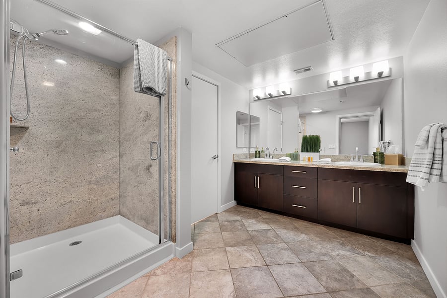 Primary bathroom with large shower, separate toilet room and double sinks