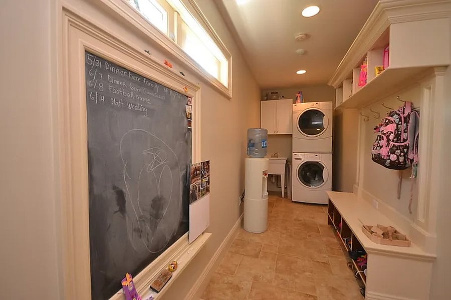 Mudroom as you enter from garage w/washer/dryer and sink. Bench seating and cubbies.