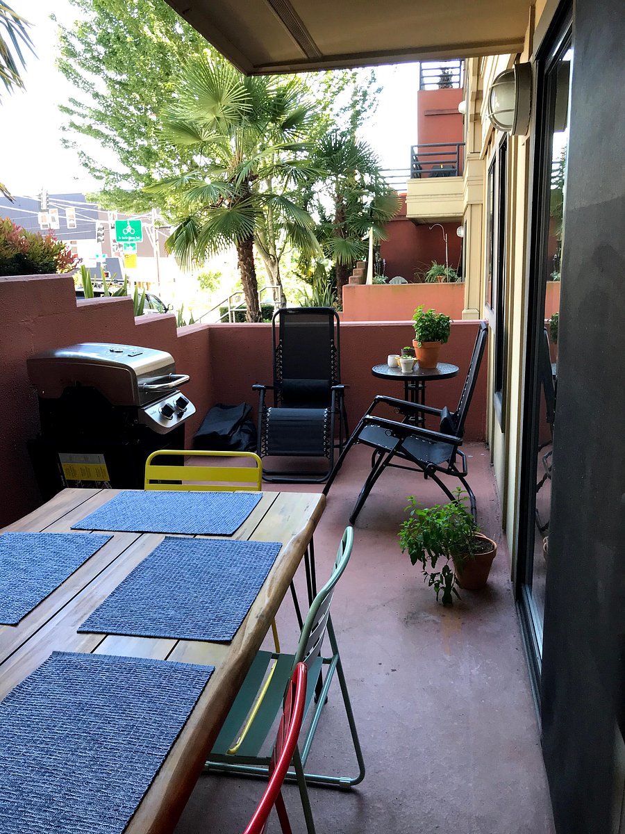 Patio with six person dining table, grill, and chairs