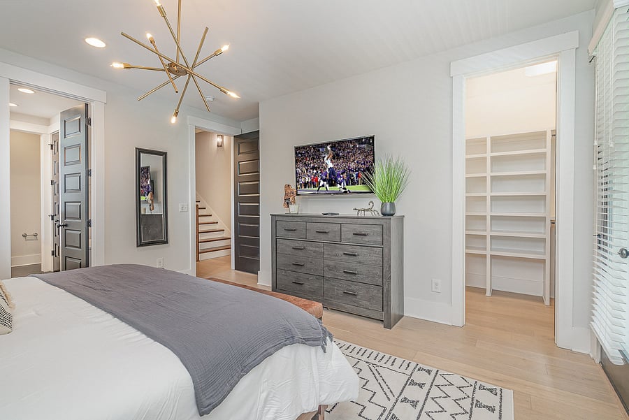 Bedroom 1 features a comfortable King bed, Smart TV, dresser, closet, and a private attached bathroom. Located on the 2nd floor, with access to a private balcony.