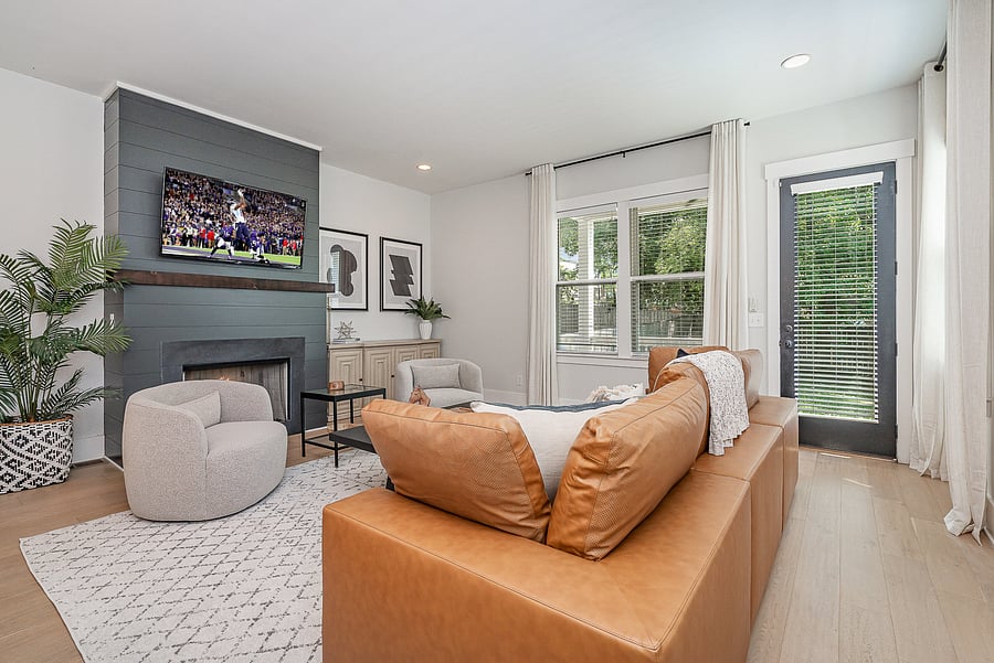 Bright and inviting living room with a cozy fireplace, featuring a comfortable sofa and a Smart TV with access to all your favorite streaming services.