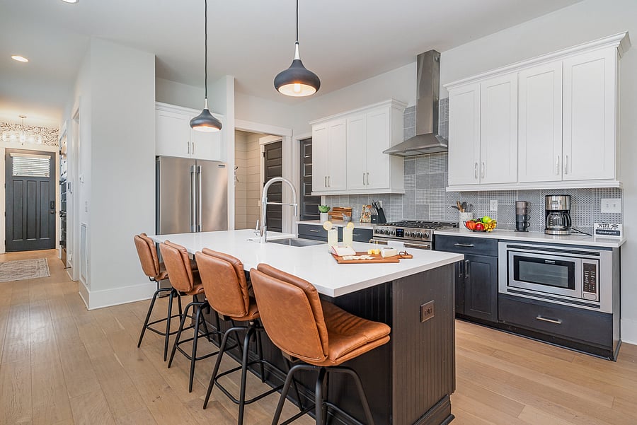 A fully equipped kitchen featuring stainless steel appliances, seating for four at the island, and all the essentials you need to cook and dine at home.
