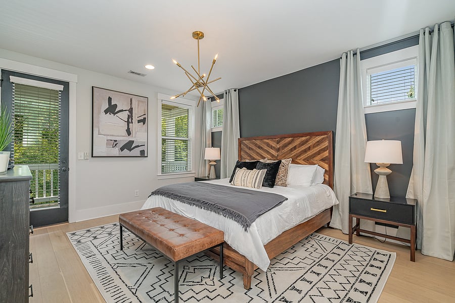 Bedroom 1 features a comfortable King bed, Smart TV, dresser, closet, and a private attached bathroom. Located on the 2nd floor, with access to a private balcony.