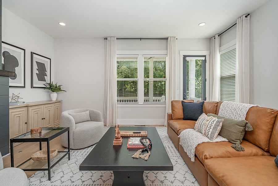 Bright and inviting living room with a cozy fireplace, featuring a comfortable sofa and a Smart TV with access to all your favorite streaming services.