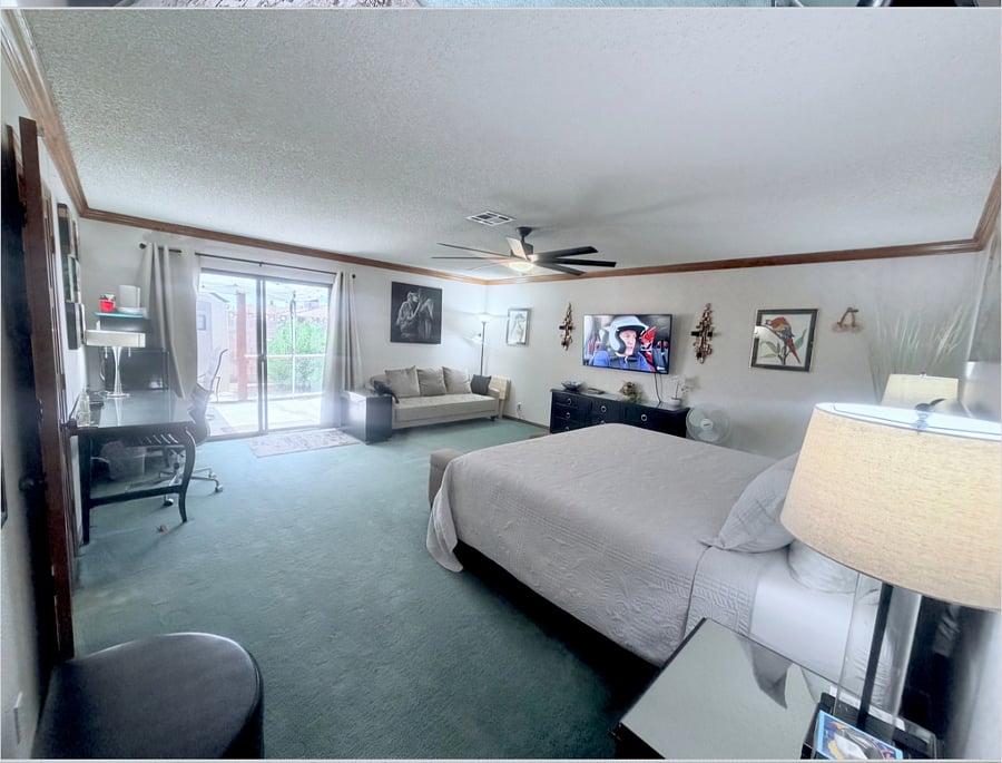 Massive 425 sqft primary suite featuring a comfortable king - size bed, a private sofa seating area, a 55" smart TV, private en-suite bathroom,walk-in closet, dedicated desk workspace.