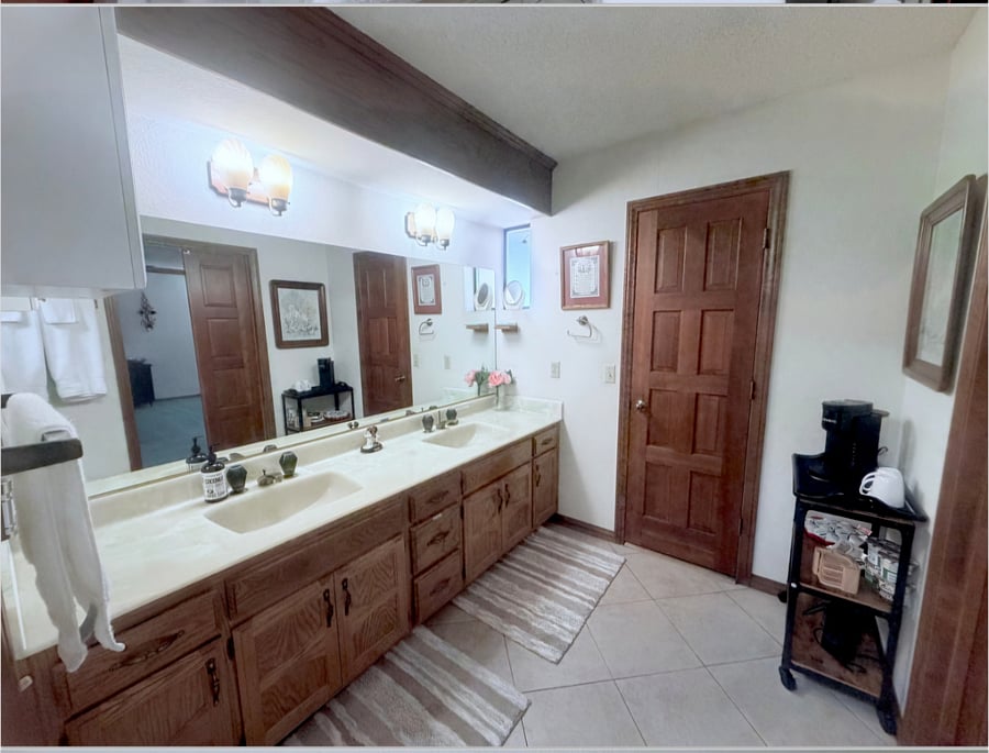 Spacious en- suite attached directly from primary bedroom, offering dual sinks, a lot of space for storage and plenty of room to get ready comfortably. Tub- shower combo.