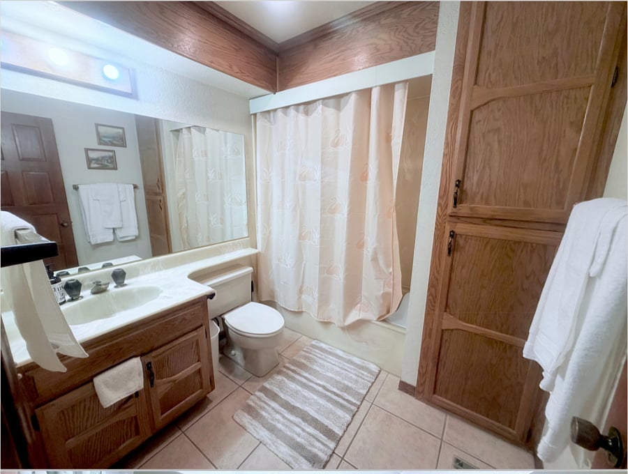 Separate full guest bathroom offering complete privacy, clean tub- shower combo, spacious vanity storage and fresh towels ready for your stay.