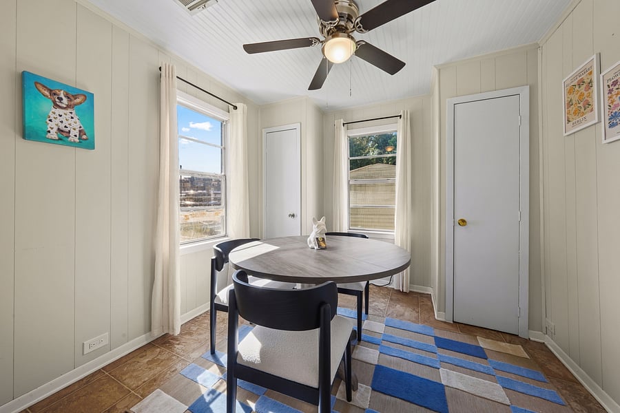 Sun-drenched office/dining nook featuring a spacious table and fun decor.  This room is inspired by our Granny and her love of dogs!