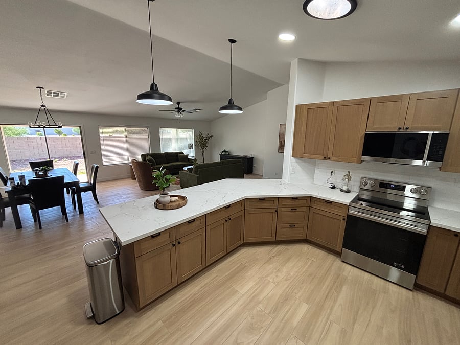 Beautifully remodeled kitchen with warm oak cabinetry, quartz counters, stainless steel appliances and stocked cooking/serving supplies including gorgeous coffee bar
