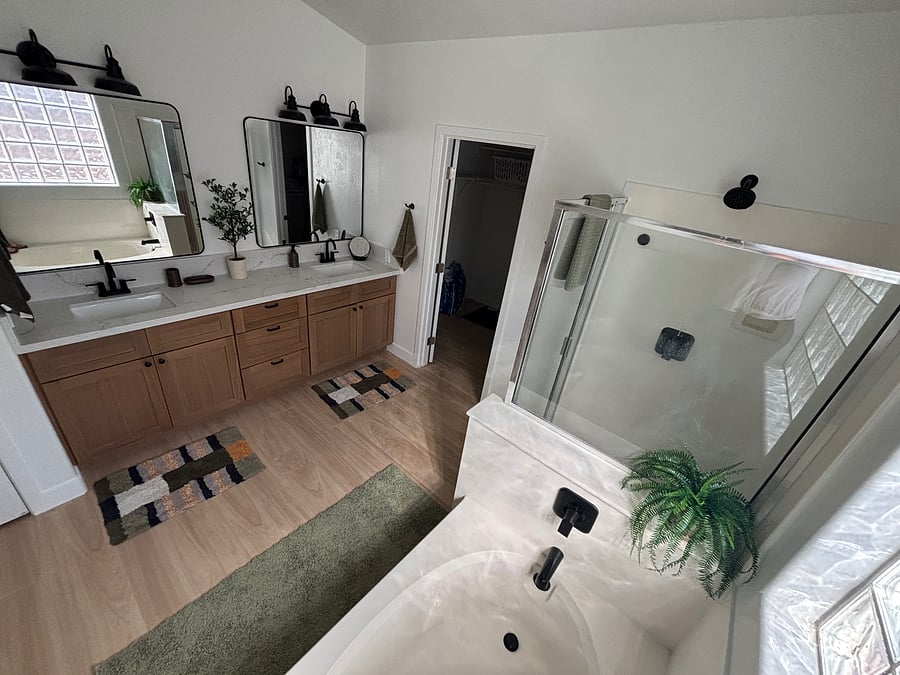 Primary bathroom with garden tub, water closet, stand up rain shower, and large walk-in closet