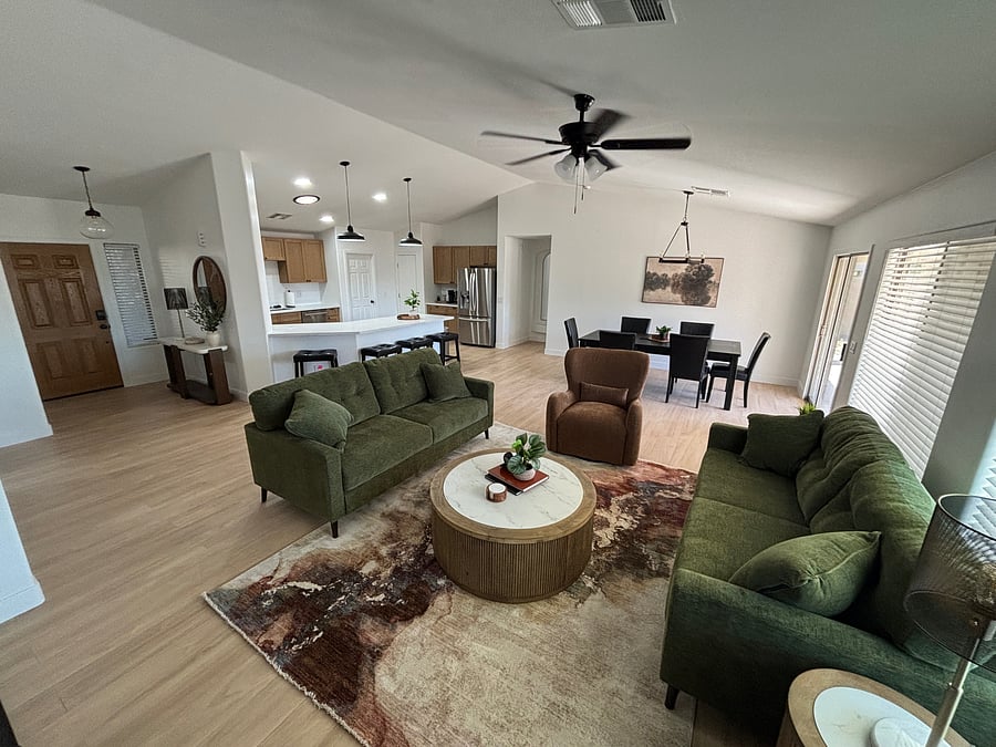 Large, inviting family room with seating for 8 at the dining table and additional bar seating