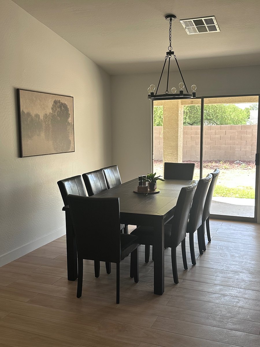 Large, inviting family room with seating for 8 at the dining table and additional bar seating