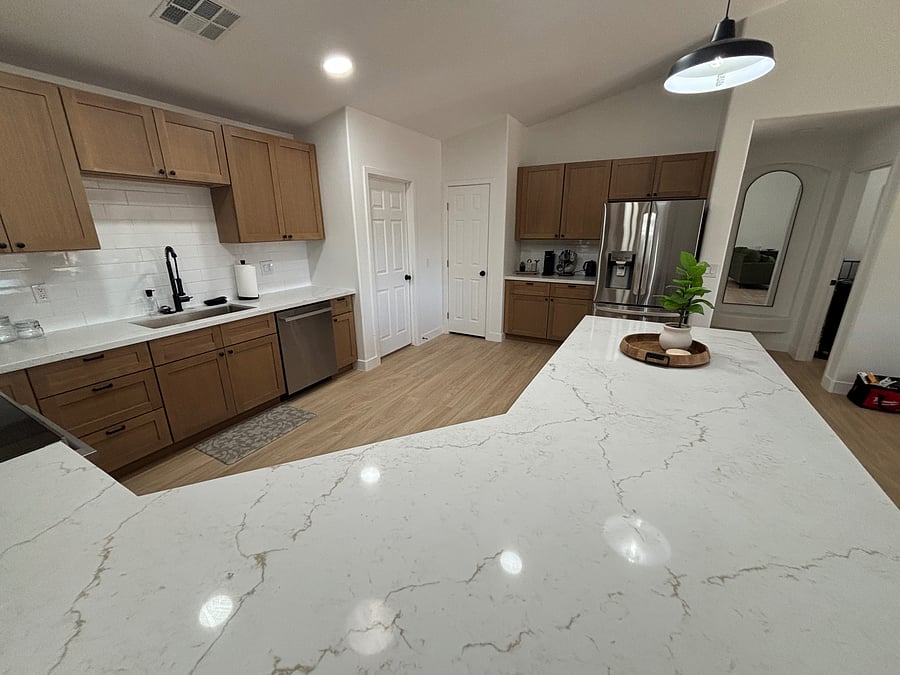 Beautifully remodeled kitchen with warm oak cabinetry, quartz counters, stainless steel appliances and stocked cooking/serving supplies including gorgeous coffee bar
